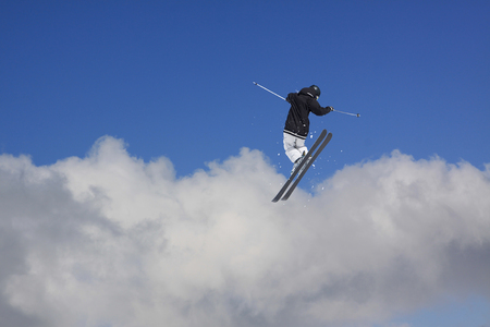 Flying skier on snowy mountains. Extreme winter sport, alpine ski.の写真素材