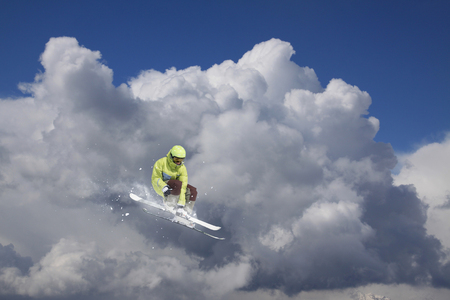 Flying skier on snowy mountains. Extreme winter sport, alpine ski.の写真素材