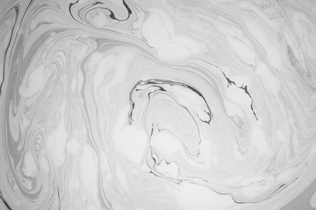 Abstract monochrome marble background. Stains of paint on the water.の写真素材