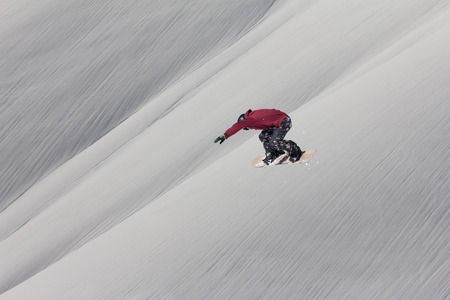 Snowboarder flying on the background of snowy slope. Extreme winter sports, snowboarding.の写真素材
