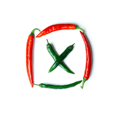 Green and red chili peppers on white background top view. Hot spicy food.の写真素材