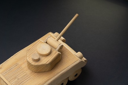 Wood tank on black background. Wooden toy tank studio shot.の写真素材