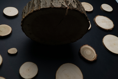 Pine tree cross-sections with annual rings on black background. Lumber piece close-up.の写真素材
