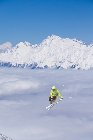 Flying skier on snowy mountains. Extreme sport, alpine ski.の写真素材