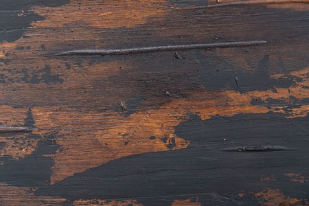 Old wooden surface background, scuffed boards with black paint stains.の写真素材