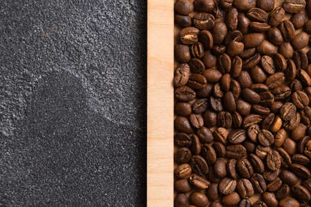 Coffee beans in wooden box on a dark background.の写真素材