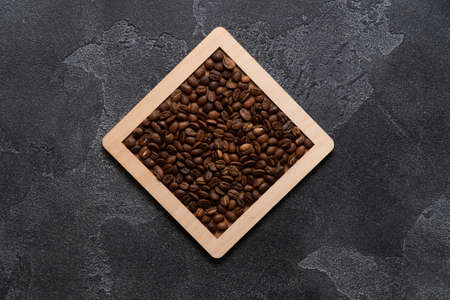 Coffee beans in wooden box on a dark background.の写真素材