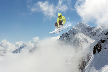 Skier jumps in the mountains. Mountain ski, winter extreme sport.の写真素材