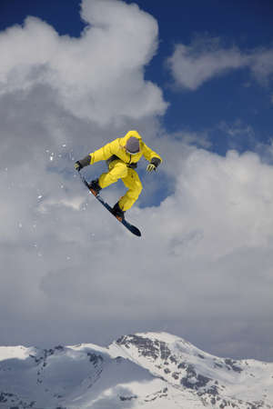 Flying snowboarder on mountains. Extreme sport.の写真素材