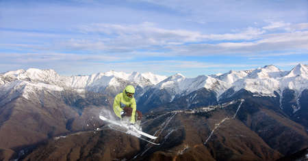Flying skier on mountains. Extreme winter sport.の写真素材