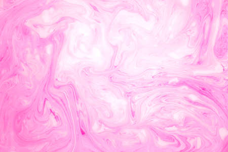 Abstract colored marble background, stains of pink paint on the surface of the water. Liquid colorful backdrop.の写真素材