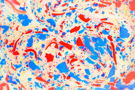Variegated colored background, paint particles on white. Dye stains on the surface of the liquid. Abstract background.の写真素材