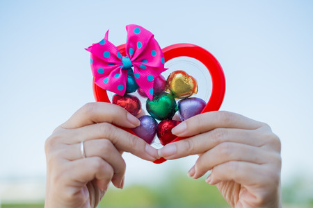 Hand of a young woman holding a chocolate heart shapedの写真素材