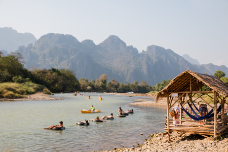 Vangviang, Laos - Feb 18 :Unidentified tourists rest in riverfront restaurant on Feb 18, 2017 in Vangviang, Laosのeditorial素材