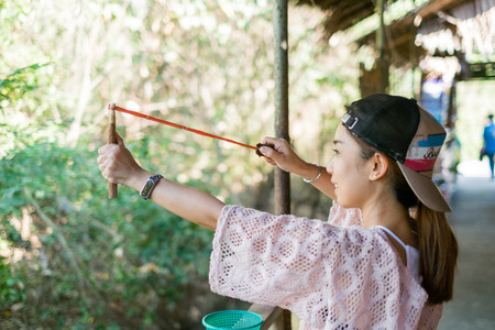 Bangkok, Thailand- Mar 19 : Thai woman holding slingshot in hands on Mar 19, 2017 in Bangkok, Thailandのeditorial素材