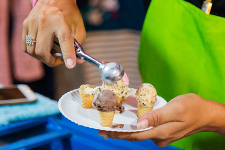 Thai people selling small ice-cream rod in small shop at street marketの写真素材