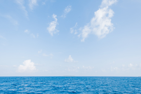 Calm Sea and Blue Sky Background in Maldivesの写真素材