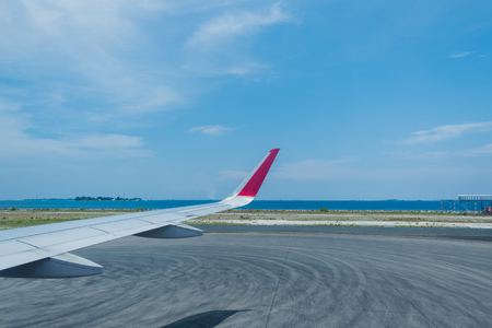 Scenery above the blue ocean from airplane window Maldives islandの写真素材