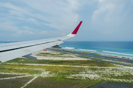 Scenery above the blue ocean from airplane window Maldives islandの写真素材