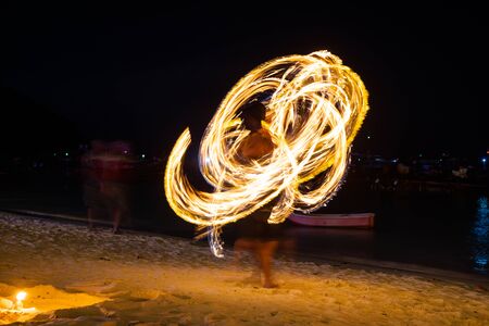 Amazing fire dancers Swing fire dancing show fire show on the beach  in Thailandの写真素材
