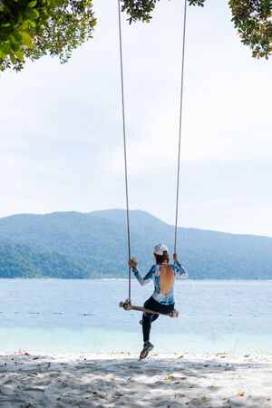 Happy Girl Enjoying Beautiful Sunrise on the beach in Satun, Thailandの写真素材