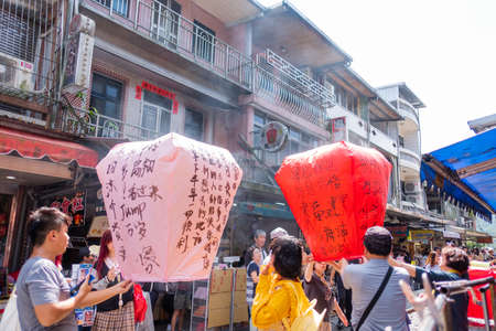 Taipei, Taiwan - Many peopleare Launching Sky Lantern Along Railway  at Shifen Old Street,Taiwan. on...