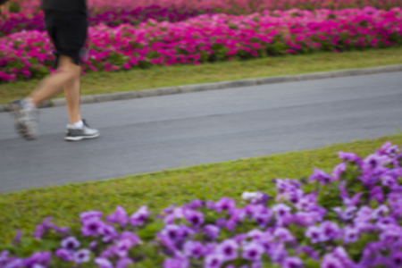 Running in flower garden. Blurred for motion feeling.の写真素材
