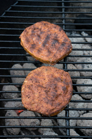 Tasty burgers on the bbqの写真素材