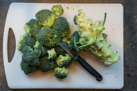 fresh broccoli sliced ??with a knife on a plateの写真素材