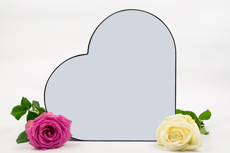 a rose with a pink rose on the side. the heart has space to put on your own text. Can be used as a backgroundの写真素材