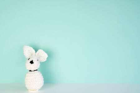 stuffed bunny toy in front of a colored background, with space next to itの写真素材