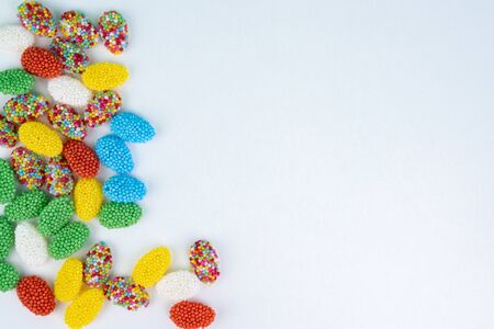 Top view of colored candy on a white background with space next to itの写真素材