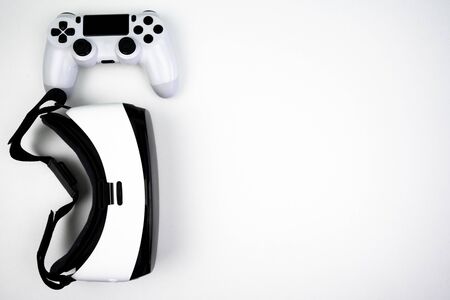 Top view of a virtual reality headset with a game controller on a white background. Having fun playing with itの写真素材