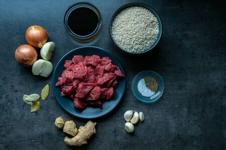 Top view of food ingredients, with meat, ingredients and beef on dark floor, Indonesian ingredients. Preparation of foodの写真素材