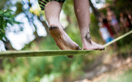 People walk on a tightrope Slacklineの写真素材