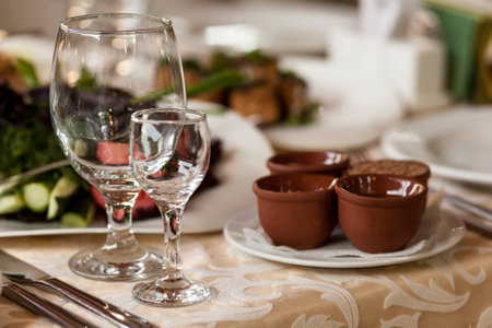 empty wine glasses on decorated table in the restaurantの写真素材