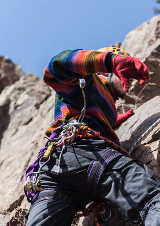 Harsh winter climber on the rockの写真素材
