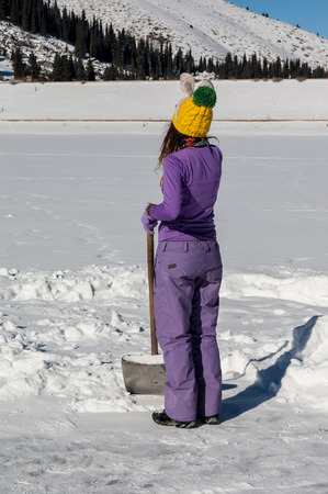 Skating on frozen mountain lake, sun and funの写真素材