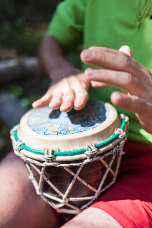 Man playing the hand drums in natureの写真素材