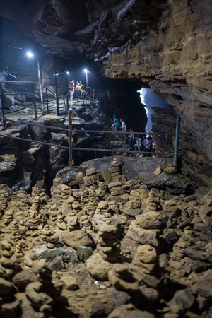 dark cave with man silhouette and water
