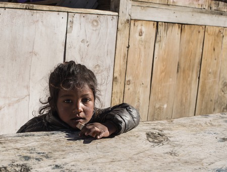 Portrait of sad teen girl sitting on the stairs at the day timeの写真素材