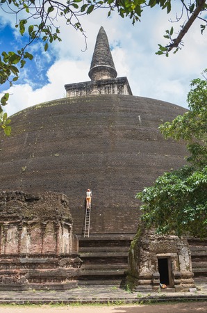 The rear of the Rankoth Vehera, the largest Buddhist stupa at the ruins of the ancient kingdom capitol of Polonnaruwa, Sri Lankaの写真素材