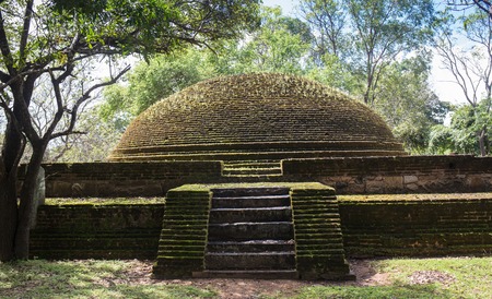 The rear of the Rankoth Vehera, the largest Buddhist stupa at the ruins of the ancient kingdom capitol of Polonnaruwa, Sri Lankaの写真素材