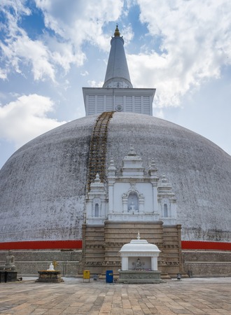 The rear of the Rankoth Vehera, the largest Buddhist stupa at the ruins of the ancient kingdom capitol of Polonnaruwa, Sri Lankaの写真素材