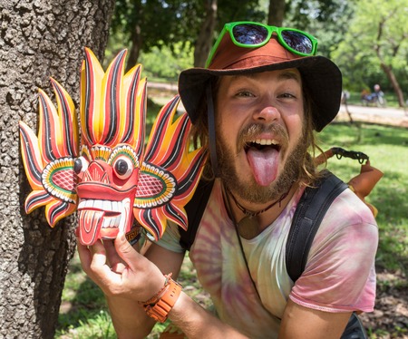 Dogon man with his traditional mask on the main square of the village Tireli