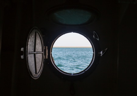 ship porthole on wooden wall on the boatの写真素材