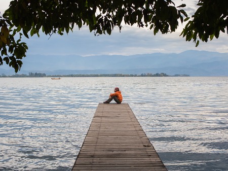 A man contemplates the ocean in the chinaの写真素材