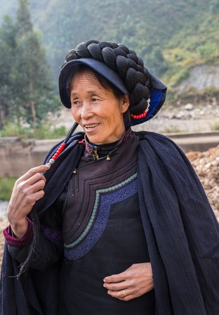 Woman in national costume with family in the chinaの写真素材