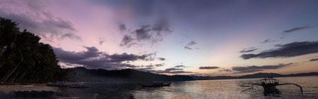 Wonderful sunset over the ocean, where the sailing boat and the coast - Philippinesの写真素材