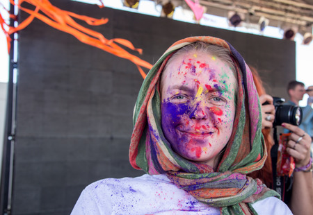 Cosmos Village, Almaty Province, Kazakhstan - 16 August 2015: The festival of ethnic music Forey, a lot of people gathers on this holiday to relax and have  fun. Ethnic open-air concert, where many people gathered. Portrait of happy young girls on holi coのeditorial素材